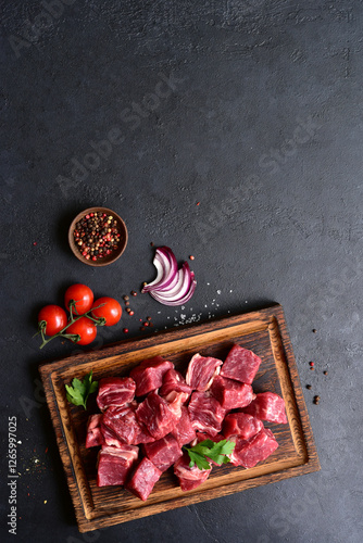 Cubes of raw organic meat ( beef or lamb ). Top view with copy space.
