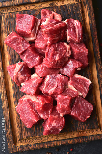 Cubes of raw organic meat ( beef or lamb ). Top view with copy space.