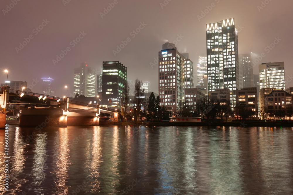 Modern cityscape with illuminated skyscrapers, bridge, and river at night Modern cityscape with illuminated skyscrapers, bridge, and river at night