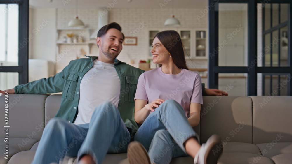 Casual couple sitting home couch closeup. Relaxed man woman laughing chilling Casual couple sitting home couch closeup. Relaxed man woman laughing chilling
