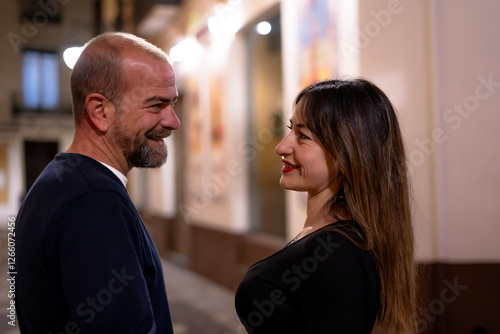 Obraz na plátně young man admiring a happy woman in the city at night