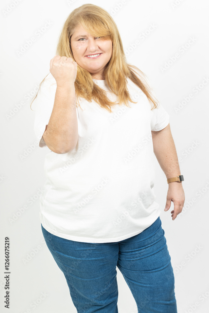 Fototapeta premium Blonde Plus Size Woman Smiling with Fist Raised in Success Gesture