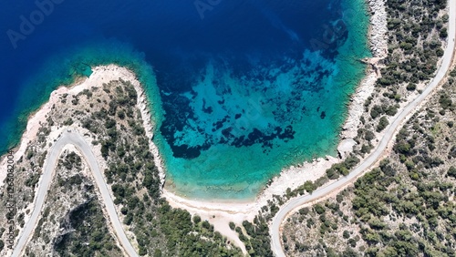 Fototapeta Naklejka Na Ścianę i Meble -  Aerial view of Kurubük Bay, a stunning hidden cove on the Mediterranean coast of Turkey. The crystal-clear turquoise waters contrast beautifully with the rocky shoreline and lush green vegetation. 