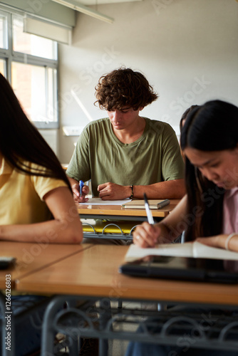 Quadro su tela Concentrated high school male student taking a written test in a classroom
