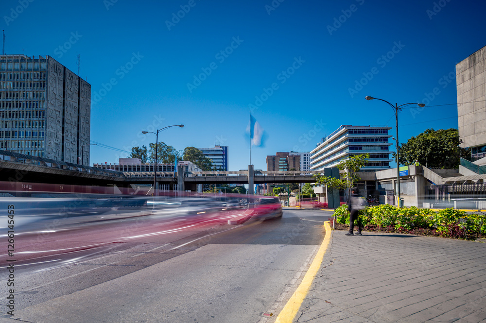 Image of an avenue with moving vehicles in Guatemala City. View of municipal government buildings and the financial system. Image at low speed. Image of an avenue with moving vehicles in Guatemala City. View of municipal government buildings and the financial system. Image at low speed.