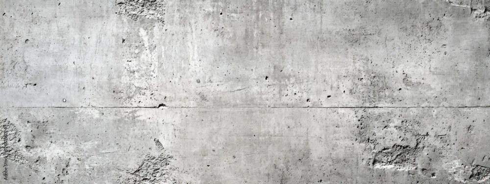 Fototapeta premium A textured concrete wall with a rough surface and subtle variations in tone.