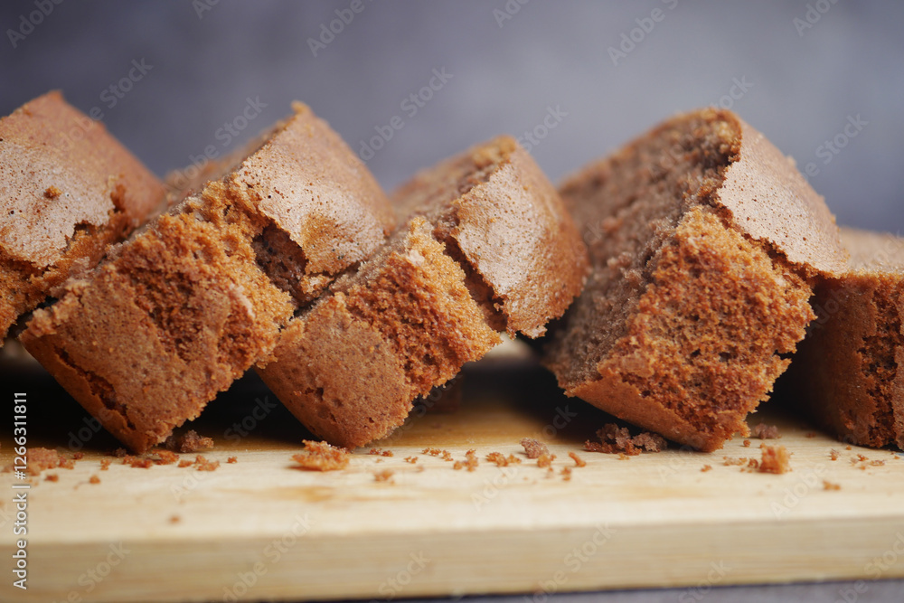 Freshly baked brown bread laid on a wooden cutting board Freshly baked brown bread laid on a wooden cutting board