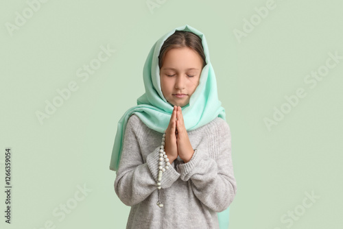 Praying Muslim girl on ligh...
