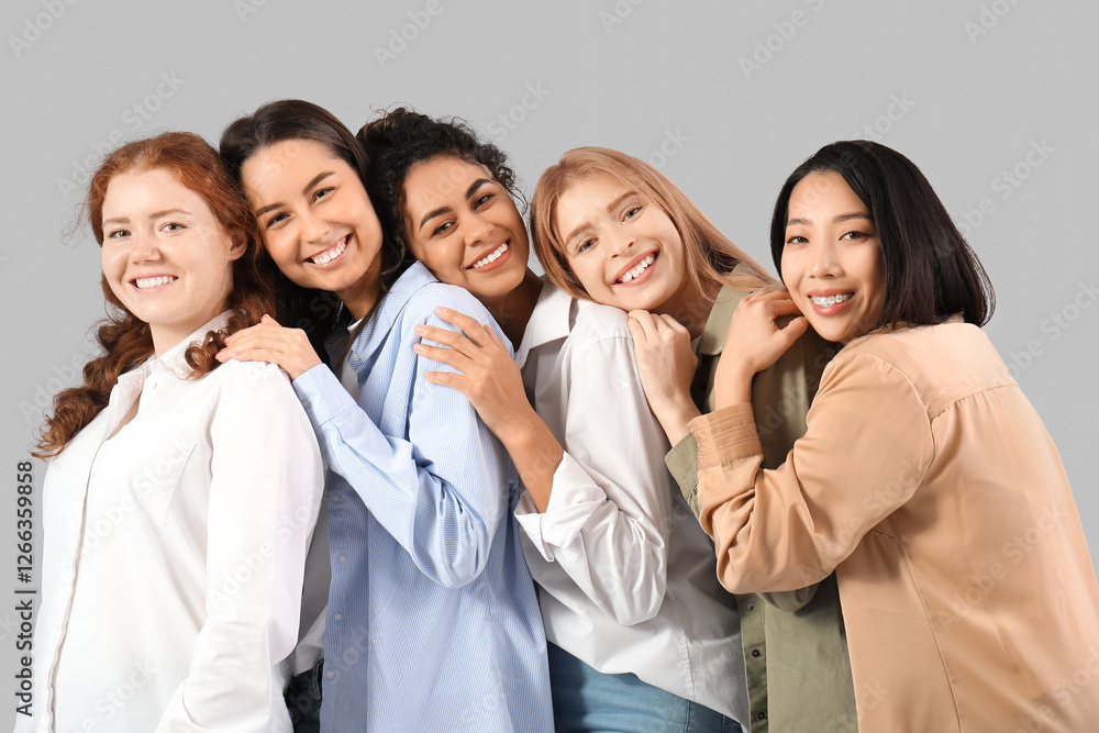 Beautiful young happy women on grey background. Women history month Beautiful young happy women on grey background. Women history month