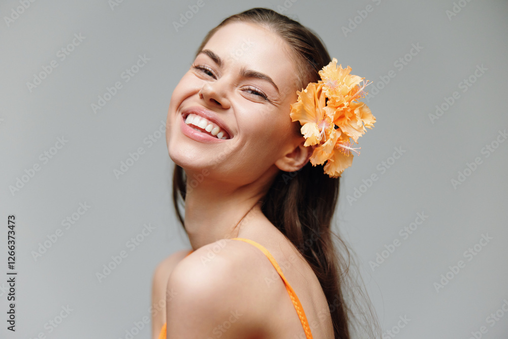 Cheerful young model with floral hair accessory exuding joy in a bright orange outfit, perfect for seasonal fashion themes. Cheerful young model with floral hair accessory exuding joy in a bright orange outfit, perfect for seasonal fashion themes.