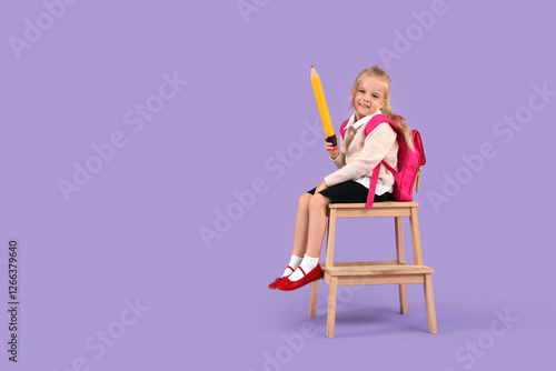 Cute little schoolgirl with...