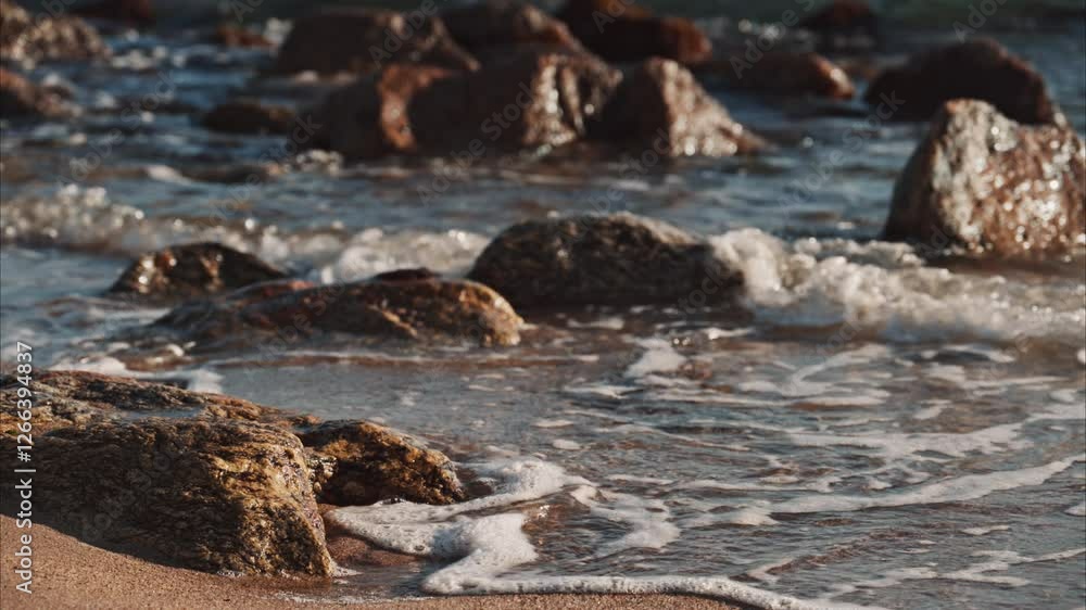 Close up of waves hitting the rocks on the beach in Cannes, France Close up of waves hitting the rocks on the beach in Cannes, France