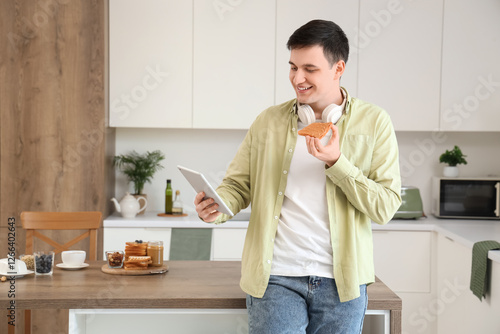 Young man holding tablet co...