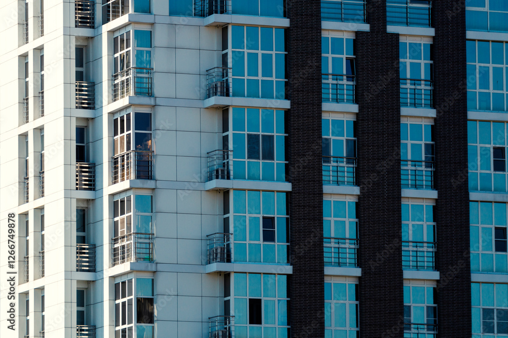 Fototapeta premium Multi-storey buildings made of glass and concrete close-up. Toned