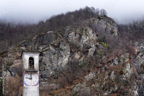 Campanile con orologio in montagna photo