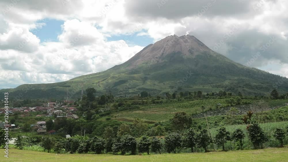 Mount Sinabung under cloudy skies, creating a dramatic and moody volcanic landscape. Perfect for nature and documentary projects. Mount Sinabung under cloudy skies, creating a dramatic and moody volcanic landscape. Perfect for nature and documentary projects.