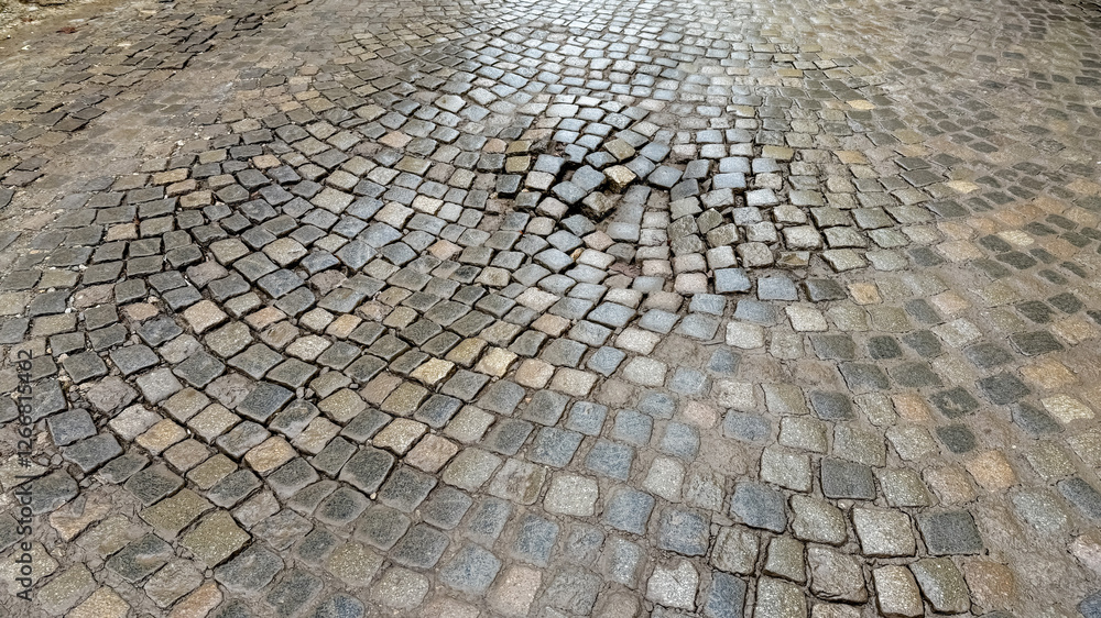 A cobblestone street with visible unevenness highlights urban infrastructure challenges and is ideal for illustrating road maintenance issues A cobblestone street with visible unevenness highlights urban infrastructure challenges and is ideal for illustrating road maintenance issues