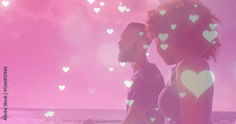 Image of hearts falling over biracial couple walking at seaside Image of hearts falling over biracial couple walking at seaside