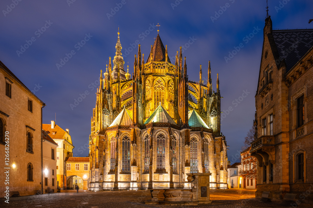 St Vitus Cathedral showcases intricate ornamental architecture illuminated at night. St Vitus Cathedral showcases intricate ornamental architecture illuminated at night.