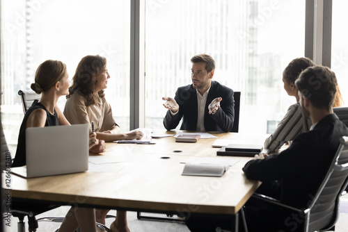 Businesspeople, professional staff members, stakeholders engaged in corporate meeting in modern high-rise office building, planning joint project, discussing collaboration, development start-up ideas