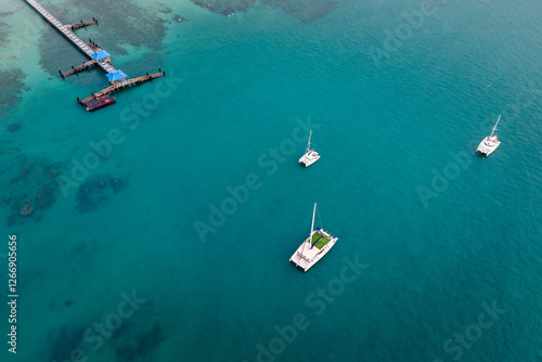 Overhead shot of Rawai Beach, Phuket, showcasing the picturesque seascape, boats, and tranquil bay. Idyllic tropical scene.