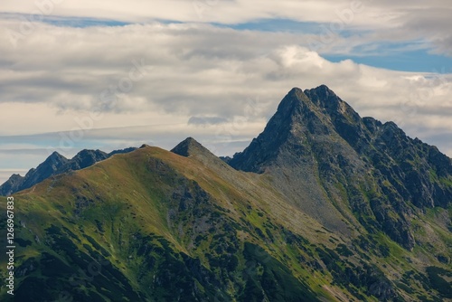 Fototapeta Naklejka Na Ścianę i Meble -  Mountain ridge in Tatras. View on tops Kasprowy Wierch and Swinica. Tatra National Park in Poland. Panorama of mountain landscape at summer in Tatras