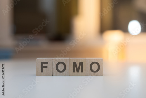 Wooden Cubes on the Table with FOMO Written on Them