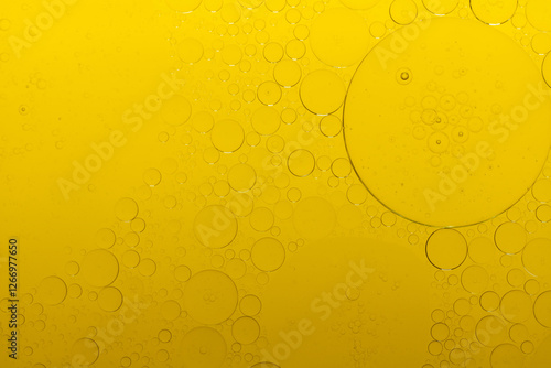 Macro microscope yellow bubble texture, Close-up Yellow bubbles and drops oil background . golden Yellow water bubbles, close up golden oil drop for celebration.