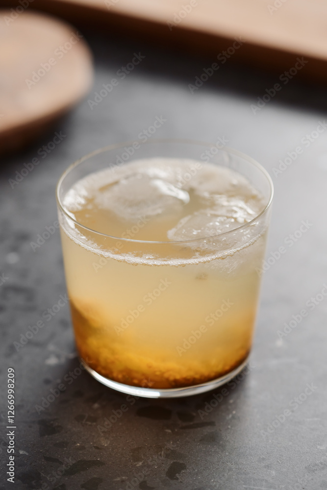 organic drink with lulo fruit in tumbler glass on concrete background with copy space