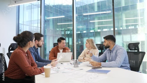 Group of business people communicate at conference meeting in office boardroom. Corporate team of professionals discussing startup strategy, engaging in decision, collaboration, communicating teamwork