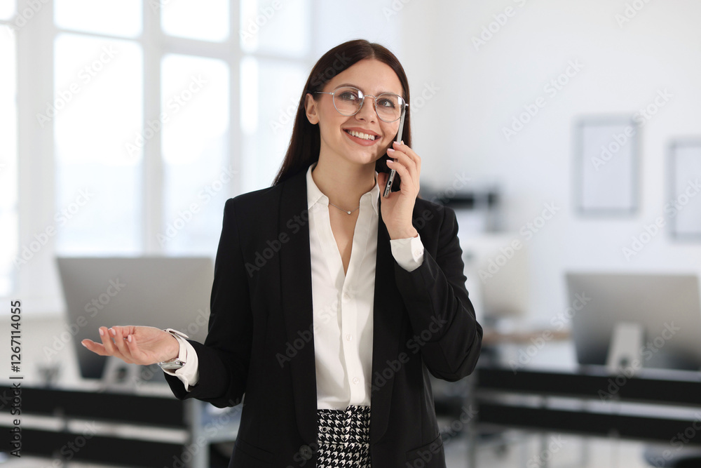 Portrait of banker talking on smartphone in office Portrait of banker talking on smartphone in office