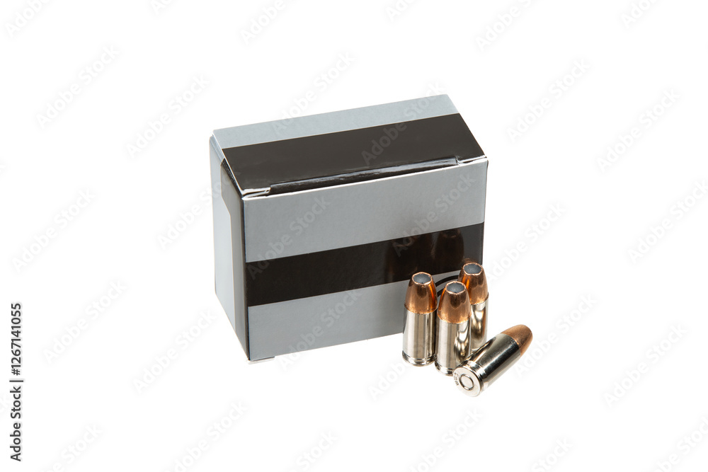 9mm ammunition, close-up view of four bullets placed beside a box, isolated on a white background. 9mm ammunition, close-up view of four bullets placed beside a box, isolated on a white background.