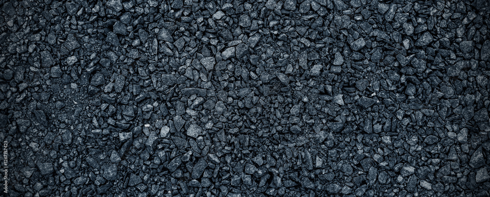 Black volcanic stone. Surface of basalt or granite close-up. Dark rough and textured rock. Black volcanic stone. Surface of basalt or granite close-up. Dark rough and textured rock.
