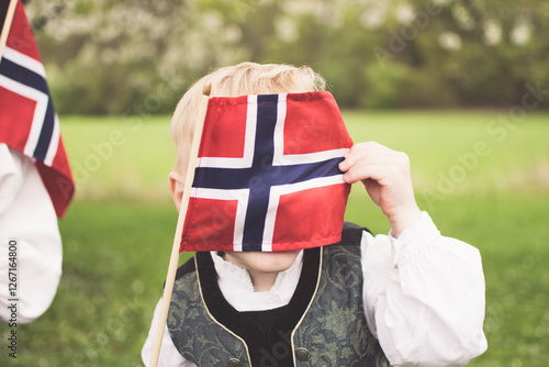 Boy with the Norwegian flag in front of his face