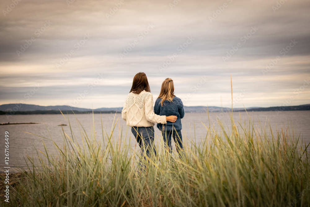 Fototapeta premium Mother and daughter together at the beach enjoying the view