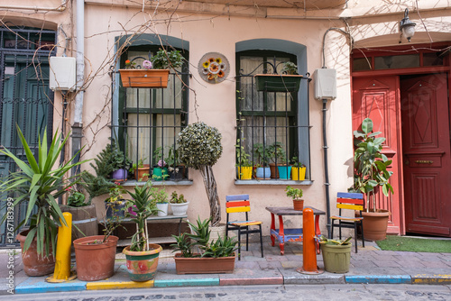 Colorful popular street corner scene in Balat, Istanbul. View of lively, beauty housefront, potted plants, red doors and yildirim street charm. Popular tourist attraction. Balat neighborhood