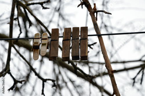 wooden clothespins on a wire
 photo