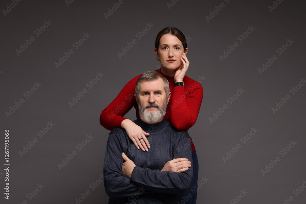 Obraz premium Family portrait of daughter and her father on dark background