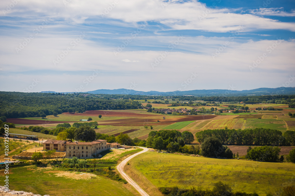Scenic view to the tuscany countryside during early September with hills on the background and fields and farms, Tuscany, Italy evokes romantic summer vacation and retreat from hustle of common days. Scenic view to the tuscany countryside during early September with hills on the background and fields and farms, Tuscany, Italy evokes romantic summer vacation and retreat from hustle of common days.