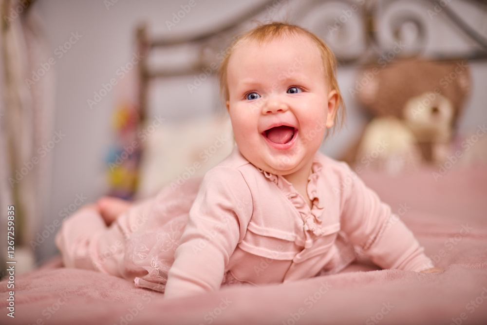 Joyful young female with light hair, caucasian ethnicity, in pink outfit on bed. Warm lighting enhances cheerful expression. Plush decor adds cozy touch Joyful young female with light hair, caucasian ethnicity, in pink outfit on bed. Warm lighting enhances cheerful expression. Plush decor adds cozy touch