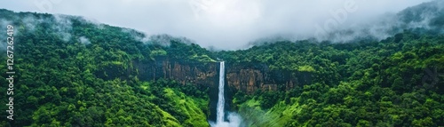 Majestic Waterfall Cascading Down Lush Green Mountains Surrounded by Mist and Dense Forest in Nature
