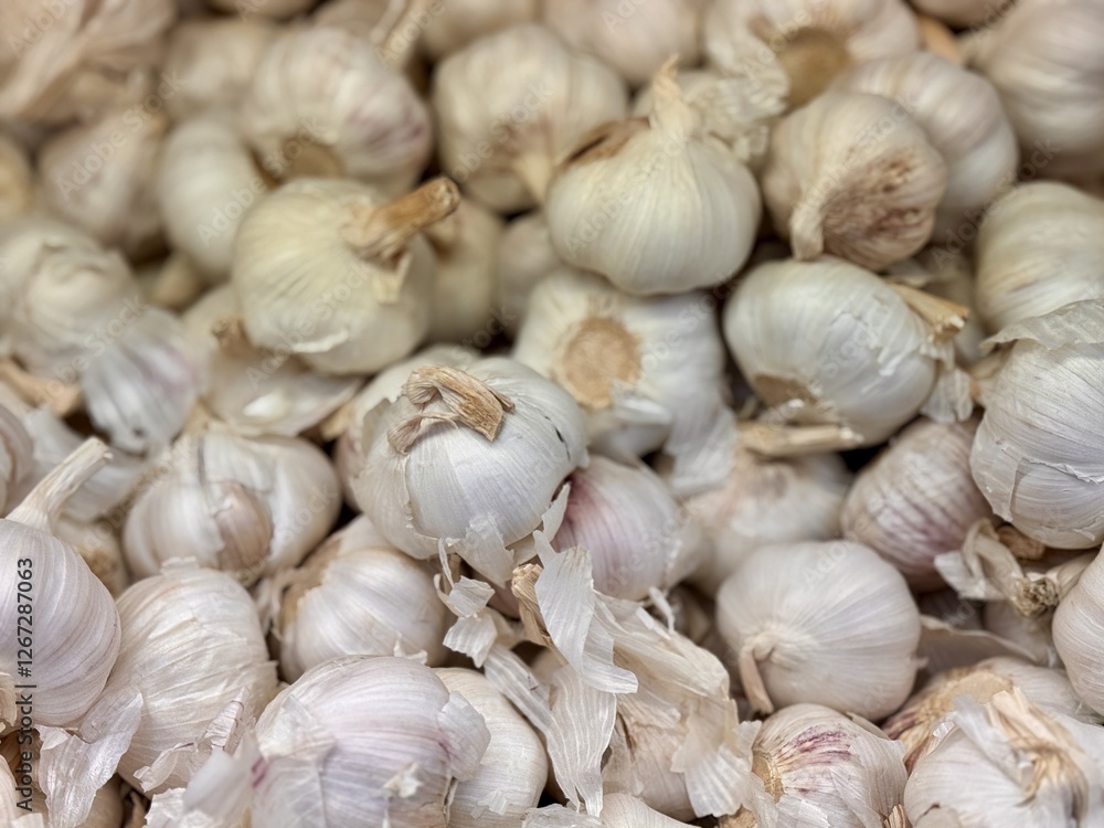 A lot of garlic in the box on sale in vegetable stand display at supermarket shop organic food, vegetarian food, healthy food A lot of garlic in the box on sale in vegetable stand display at supermarket shop organic food, vegetarian food, healthy food