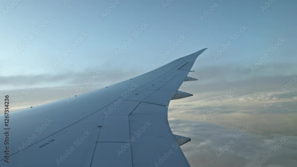 Aircraft wing flying at cruising level with clouds on the ground. Concept: Travel, aeronautics, airplane, airplane wing. Aircraft wing flying at cruising level with clouds on the ground. Concept: Travel, aeronautics, airplane, airplane wing.