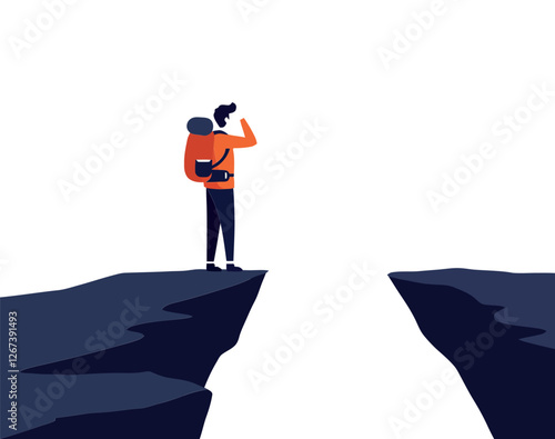 Hiker standing on edge of a cliff looking towards a distant gap