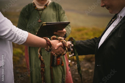 Принти на полотні Details of a pagan handfasting ceremony with a weaved ribbon in Iceland