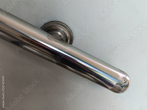 Close Up Metal Handrail Attached To White Wall For Support And Safety In Interior Design