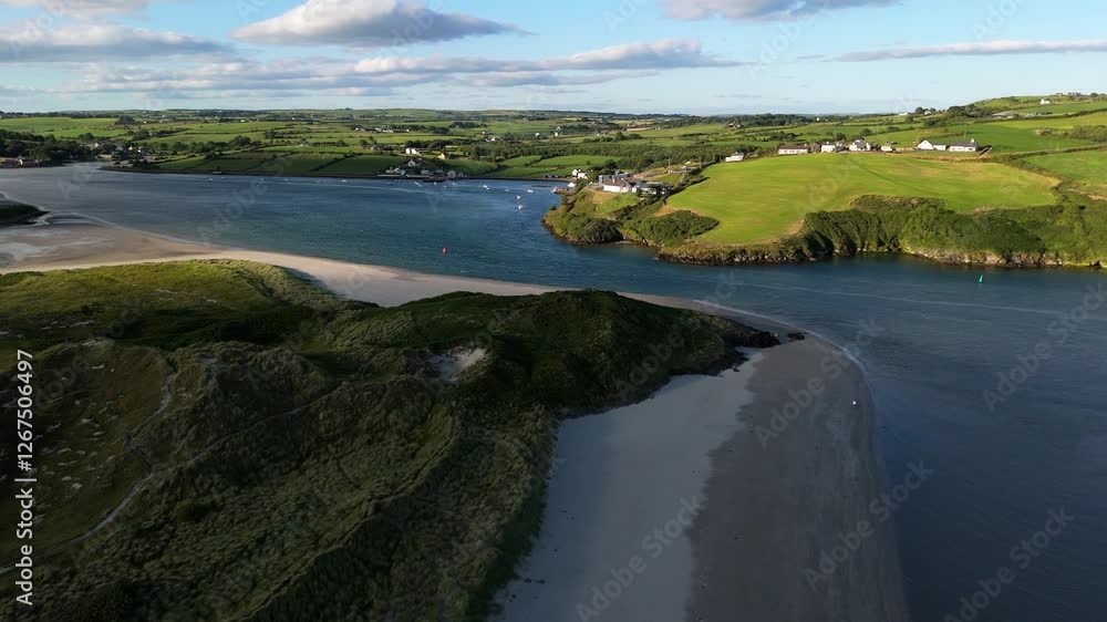 A tranquil bay winds through verdant landscapes, with gentle waves lapping at the shore. Boats drift in the distance as evening light enhances the scenery. A tranquil bay winds through verdant landscapes, with gentle waves lapping at the shore. Boats drift in the distance as evening light enhances the scenery.