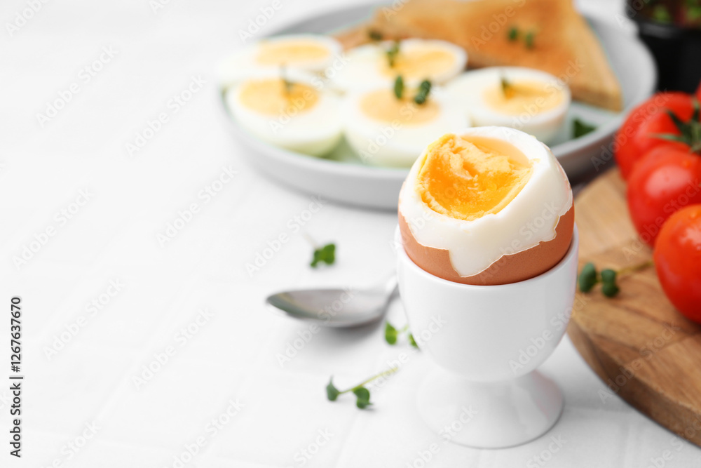 Soft boiled egg on white tiled table, closeup. Space for text Soft boiled egg on white tiled table, closeup. Space for text