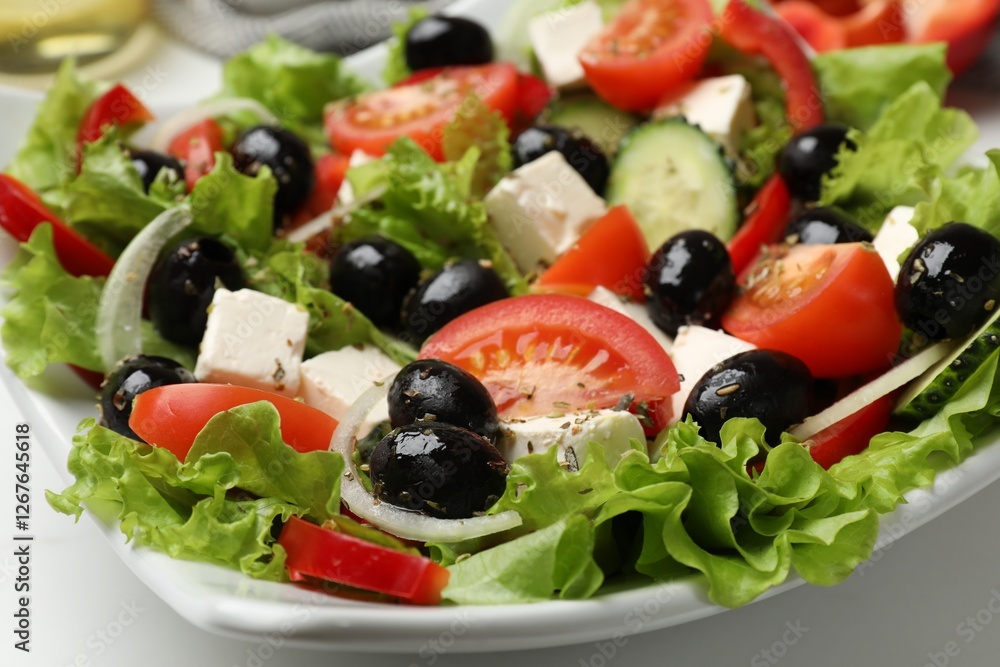 Delicious fresh Greek salad on white table, closeup
