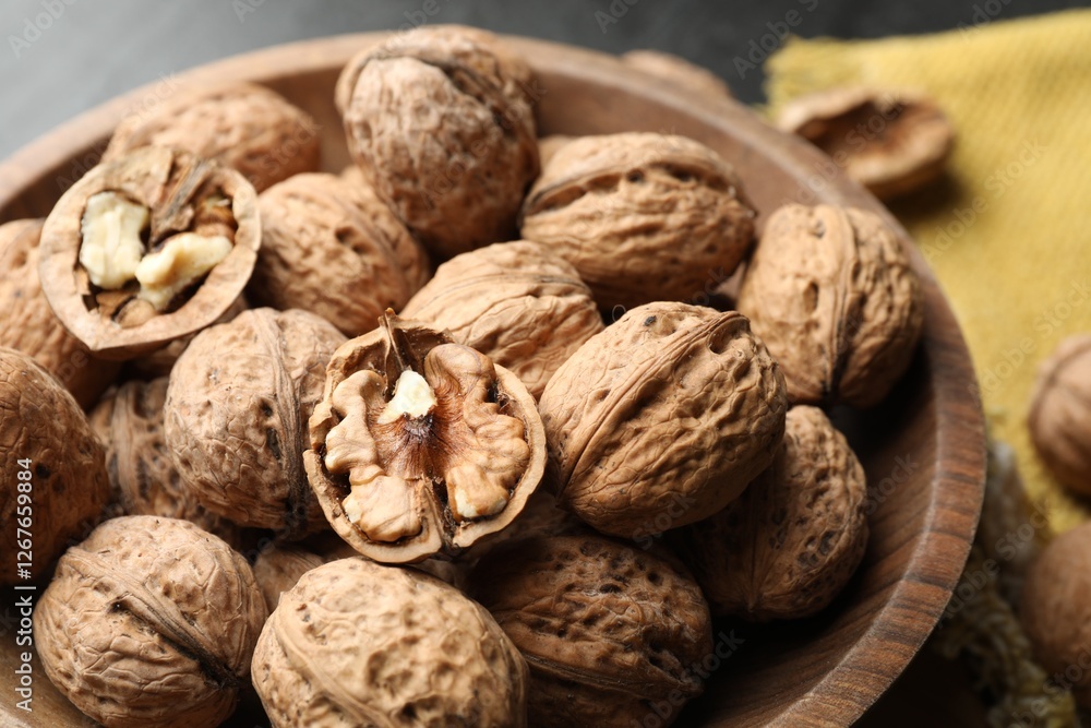 Fresh ripe walnuts in shells on table, closeup Fresh ripe walnuts in shells on table, closeup